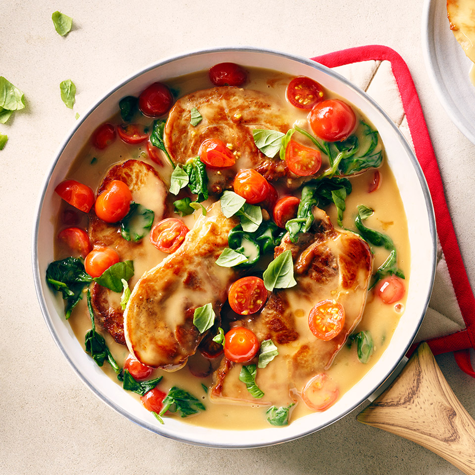 CAMPBELL'S® Saucy Pork Chops with Spinach and Tomatoes